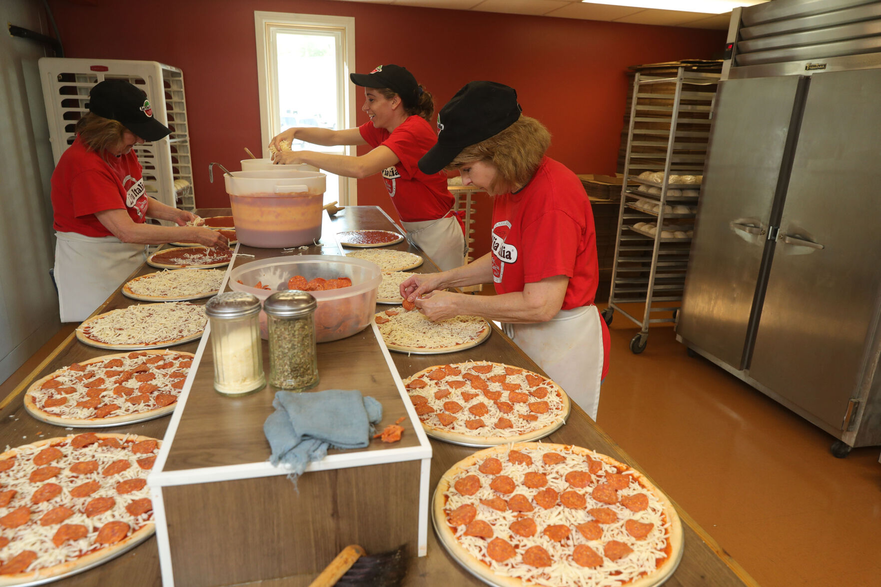 Putting on the pepperoni